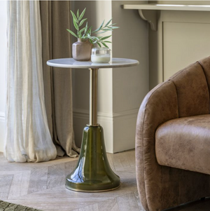 Bilbao Side Table.  A marble top with gold stem and green base with vase and candle  sat on it