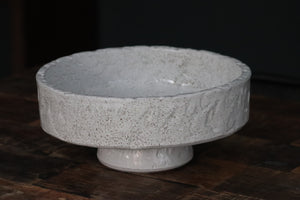 empty white textured bowl made from terracotta sat on wooden table