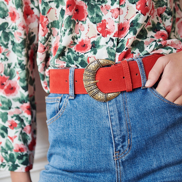 Red suede belt with a large crescent moon brass colour buckle