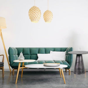 Black Aluminium side coffee table next to a green sofa with a white table near it