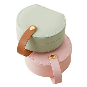 two personalised pink and sage green jewellery case holders, with leather effect handle on a white background 