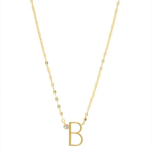 Personalised Gold Letter And Diamond Necklace against a white background. The letter B is shown. Gold chain with diamond sitting next to the letter